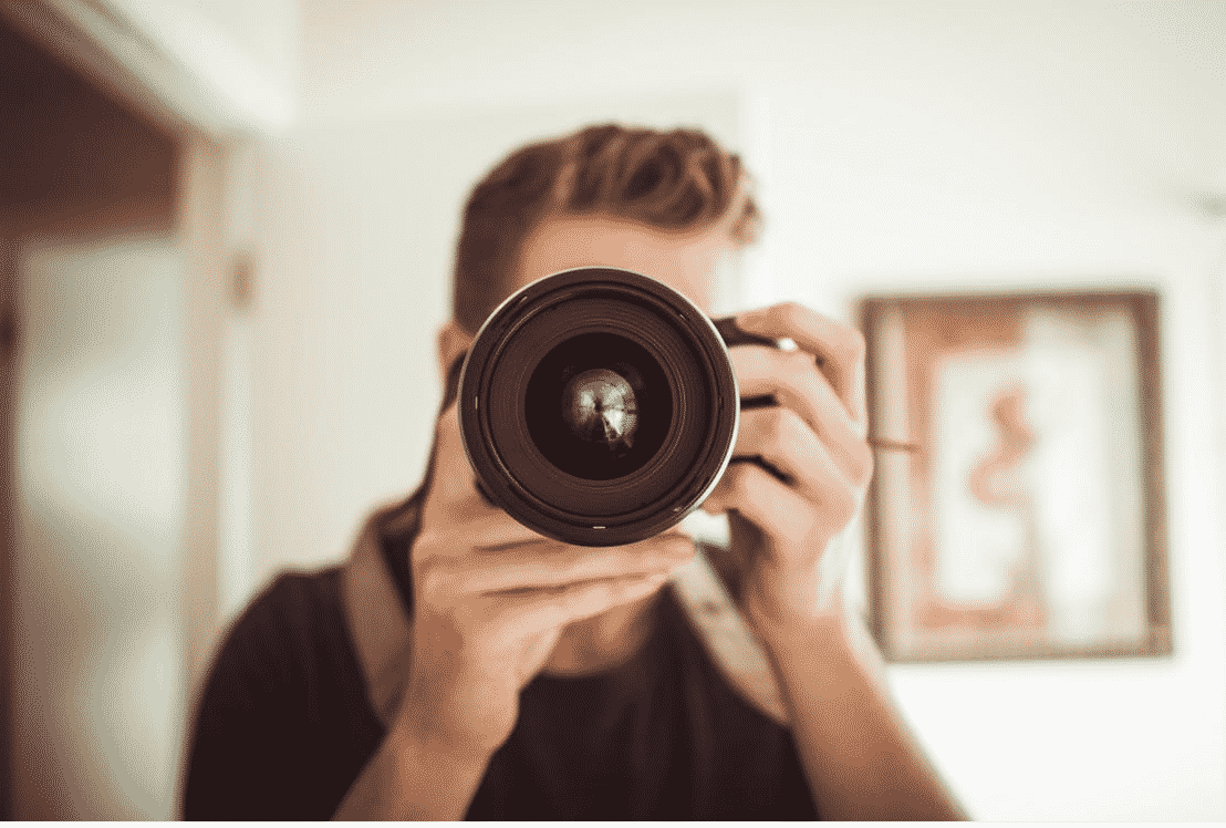 Person holding a camera, focusing on video production technology trends in 2017.